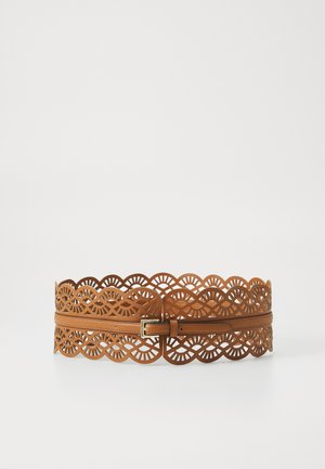 Brown leather belt featuring a cut-out design with wavy edges and circular patterns, secured with a metallic buckle.