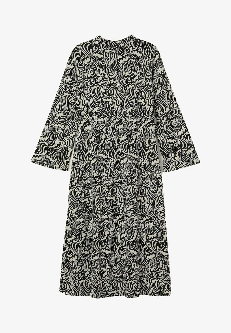 Pitkähihaiset mustavalkoinen mekko, jossa on abstrakti pyörteilevä kukkakuvio ja korkea kaulus.