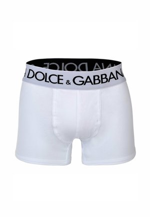 Witte katoenen boxershorts met een zwarte elastische tailleband waarop het logo "DOLCE & GABBANA" in hoofdletters is afgebeeld. Gladde textuur, strak design.
