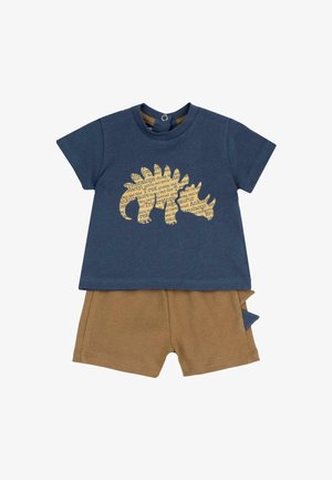 Chemise pour tout-petit bleu marine avec une silhouette de dinosaure composée de noms de dinosaures, accompagnée d'un short marron doté d'un petit détail de queue en tissu.