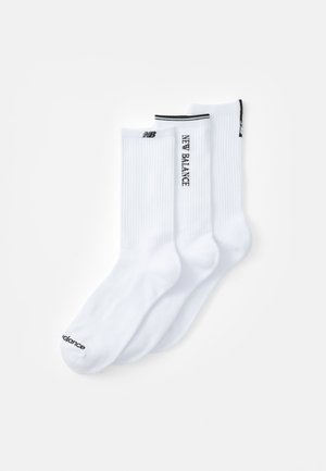 Three pairs of knee-length socks in white cotton blend. Features ribbed texture and black logo accents at the top and toe.