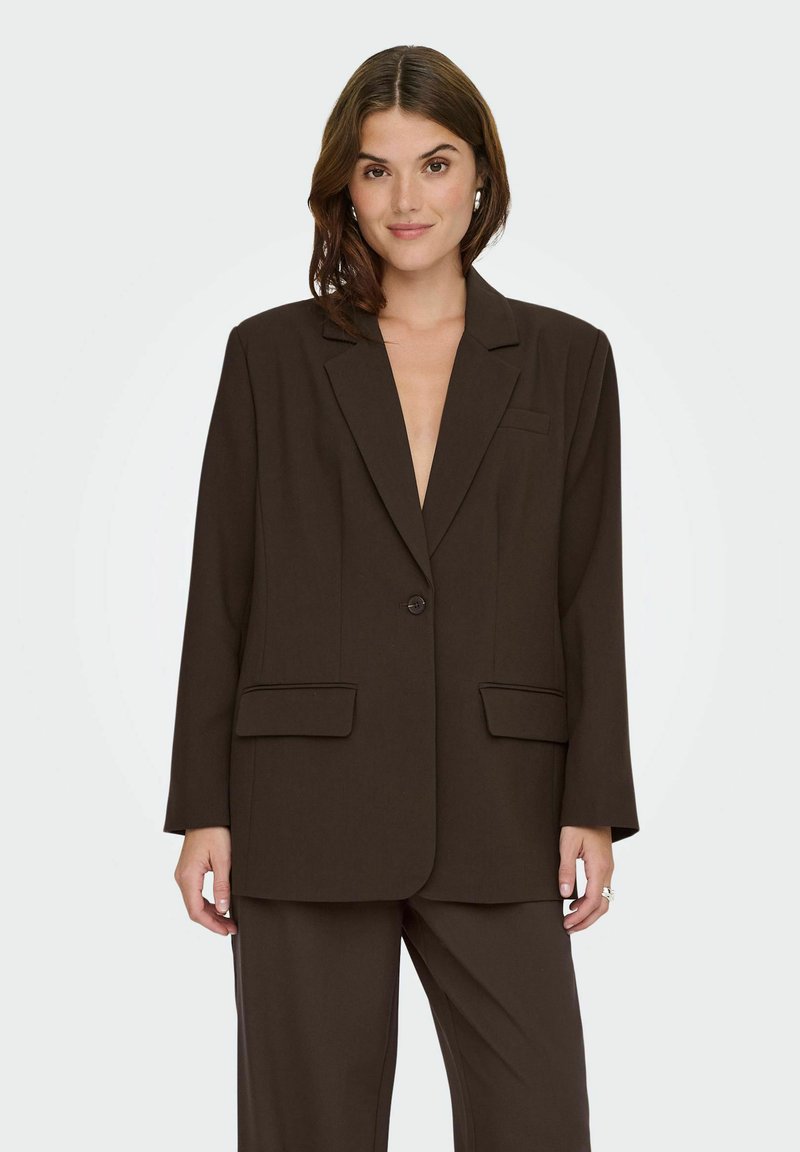 Blazer marron en tissu léger, design structuré avec des manches longues, deux poches avant et fermeture à bouton unique.