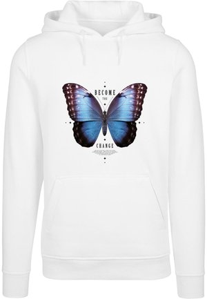 Un sweat à capuche blanc arborant un grand motif de papillon bleu avec des accents noirs et le texte "DEVIENS LE CHANGEMENT" sous le papillon.