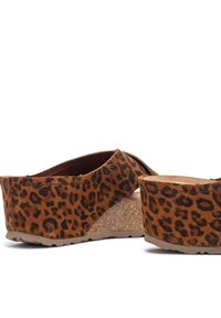 Brown leopard print platform sandals with a soft suede texture, cork midsole, and rubber outsole. Crossed straps provide secure fit.