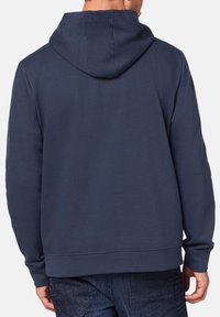 Navy blue hoodie made of cotton blend, featuring a drawstring hood, long sleeves, and a plain back design with ribbed hem and cuffs.
