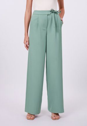 Light green wide-leg trousers with a fabric tie belt, pleated front, and side pockets. Smooth texture and full-length design.