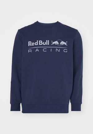 Námornícky modré mikina s dlhými rukávmi, okrúhlym výstrihom a predným logom Red Bull Racing. Hladká textúra, rebrované manžety a lem.