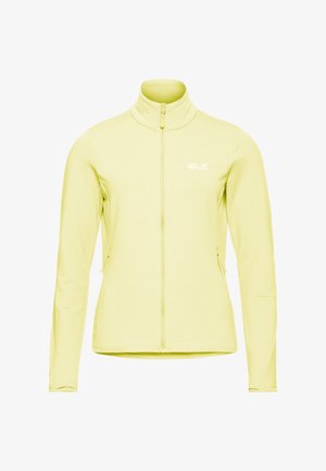 Veste jaune à fermeture éclair fabriquée en tissu léger et texturé. Elle présente un col haut et deux poches latérales zippées. Logo de la marque en haut à gauche.