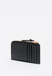 Cartera de cuero negra con relieve de cocodrilo y cierre de cremallera, que cuenta con cuatro ranuras para tarjetas y una textura suave. Acento de hardware dorado.