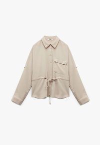 Lichtbeige blouse van zachte stof, met een kraag, knopen aan de voorkant, een borstzak, elastische tailleband en een trekkoordaccent.