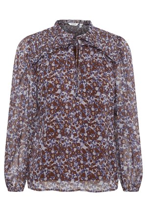 Blusa trasparente floreale marrone e viola con maniche lunghe, scollatura arricciata, dettaglio a chiave sul davanti e polsini elasticizzati. Tessuto leggero e fluido.