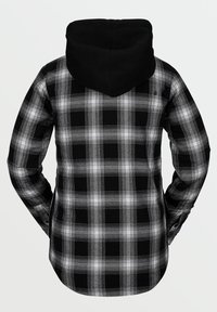 Sorte og hvide ternede flannel skjorte med sort hætte. Har lange ærmer og en lige skåret kant. Bagfra ses detaljer i ternet mønster.