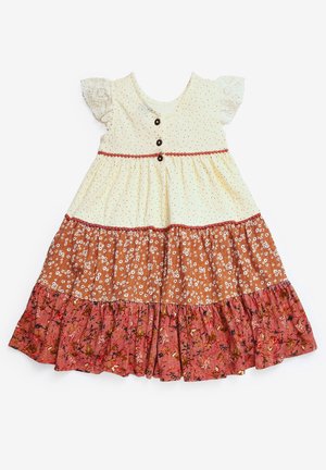 Robe pour tout-petit avec manches en dentelle crème, boutons sur le haut et trois couches de tissu à motif floral en nuances crème, orange et rose.