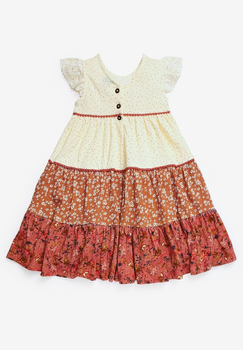 Robe pour tout-petit avec manches en dentelle crème, boutons sur le haut et trois couches de tissu à motif floral en nuances crème, orange et rose.
