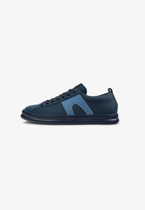 Navy and blue suede sneaker with stitching details, rounded toe, lace-up front, and a flexible rubber sole. Accented with a logo on the side.