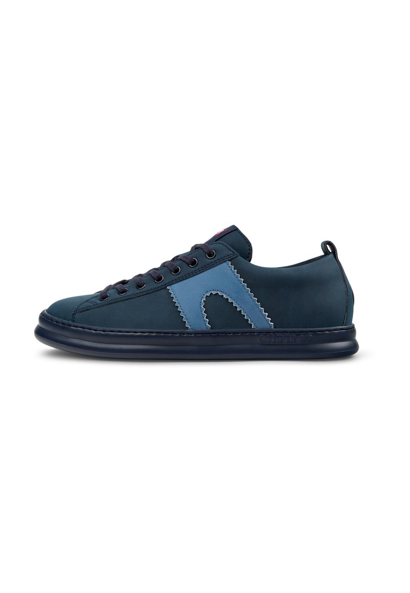 Navy and blue suede sneaker with stitching details, rounded toe, lace-up front, and a flexible rubber sole. Accented with a logo on the side.