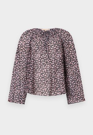 Blouse noire en transparence avec des manches longues, ornée d'un motif floral de fleurs roses et blanches, avec un col froncé et une coupe ample.