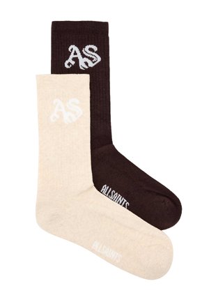 Kaksi pitkää puuvillasukkaa, yksi beige ja yksi tummanruskea, kummassakin "AS"-alkuiset nimikirjaimet resorissa ja "AllSaints" jalan kohdalla.