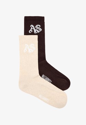 Deux longues chaussettes en coton, une beige et une brun foncé, chacune avec les initiales "AS" sur le revers et "AllSaints" sur le pied.