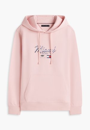 Világos rózsaszín kapucnis pulóver elején zsebbel, húzózsinórokkal és "Miami 2025-1985" felirattal, valamint apró logókkal a mellrészen.