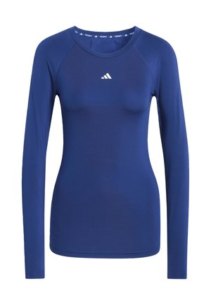 Pitkähihaiset urheilupaita tummansinisestä kankaasta. Siinä on pyöreä pääntie, litteät saumat ja pieni valkoinen logo rinnassa.