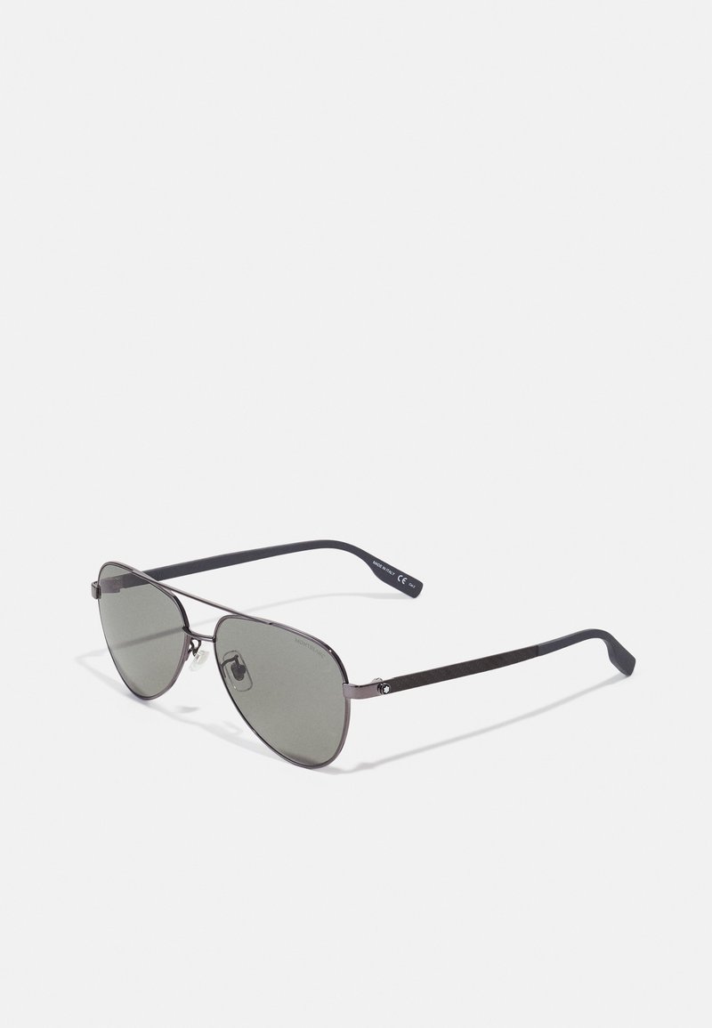 Occhiali da sole in metallo stile aviator con lenti grigie. Caratterizzati da una montatura sottile e punte nere eleganti. Design minimalista senza branding visibile.