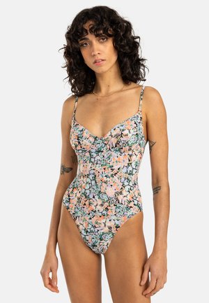 Maillot de bain une pièce fleuri avec bretelles réglables, présentant un mélange de fleurs vert pastel, orange et rose sur un fond sombre.