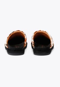 Black slide sandals with a patterned upper made of soft fabric. Features a smooth, padded interior and a sturdy rubber sole.