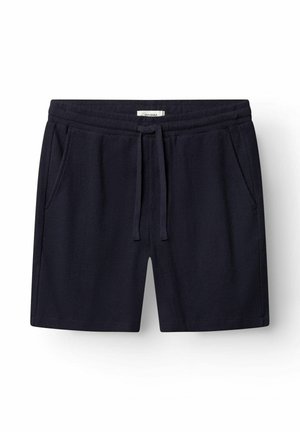 Marineblå bomuldsshorts med elastisk talje, justerbar snor og sidelommer, lagt fladt på en hvid baggrund.