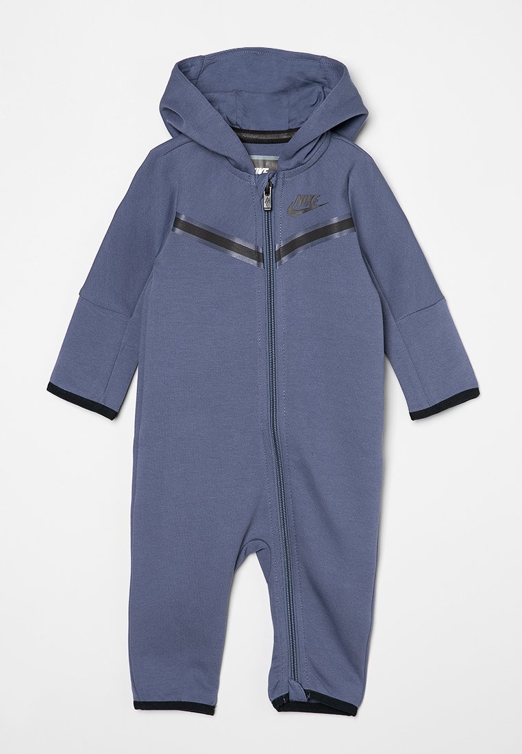 Nike zip-up eendelig in donkerblauw met een capuchon, zwarte accenten, lange mouwen en een vooraan кел voor rits. Gemaakt van zachte, rekbare stof.