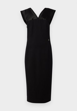 Black dress with a fitted silhouette, cap-like satin sleeves, V-neckline, and subtle side accent. Smooth fabric texture, knee-length.