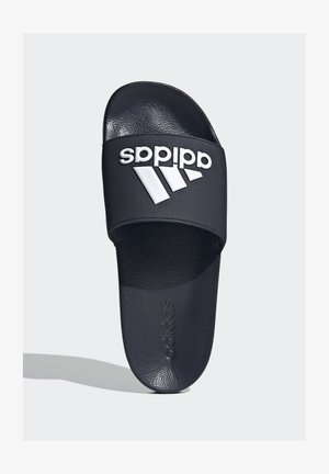 Black slide sandal with textured strap, featuring a white Adidas logo and three diagonal stripes on the upper surface. Soft footbed.