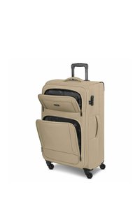 Valise souple beige avec poignée télescopique, quatre roues pivotantes et deux compartiments avant zippés ouverts sur un intérieur doublé de noir.