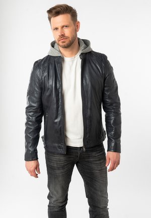 Lederjacke in Dunkelblau mit grauem Kapuzeneinsatz, Reißverschluss und Slim-Fit. Verfügt über strukturiertes Leder und subtile Schultersteppungen.