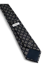 Jūras spēku krāsas kaklasaites ar beižainu ziedu rakstu, izgatavota no strukturētas auduma. Gals ir vienkrāsains jūras spēku krāsā, un netālu no šaurā gala ir redzama zīmola birka.