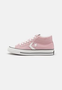 Pink high-top sneakers made of canvas, featuring a white star logo, white laces, black outsole, and contrasting black stripe detail.
