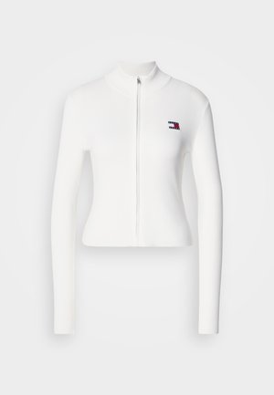 White ribbed zip-up jacket with long sleeves and a high collar. Features a small multicolored logo on the upper left side.