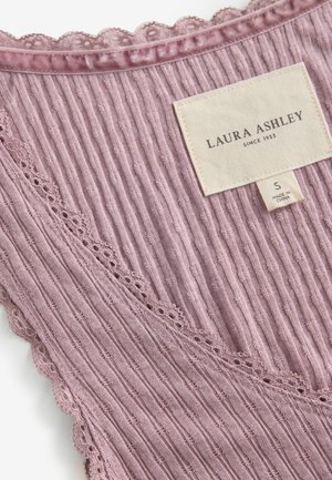 Ribbed, light mauve fabric tank top featuring scalloped lace trim, a tag with "Laura Ashley" branding, and a size label.