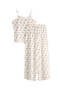 Kremowy komplet piżamowy z topem na cienkich ramiączkach i szerokimi spodniami, zdobiony wzorem małej brązowej wiewiórki i niebieskich kwiatów.
