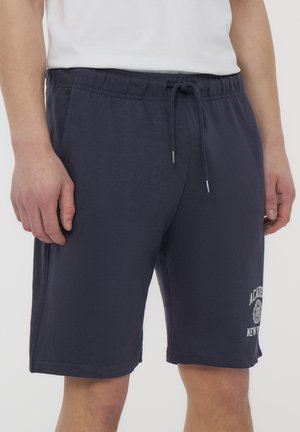 Pantaloni corti blu navy, realizzati in cotone morbido, presentano un elastico in vita con cordino e un logo stampato sulla gamba sinistra. Vestibilità regolare.