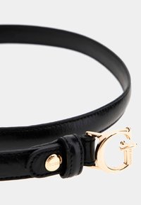 Cintura in pelle sintetica nera con una fibbia a forma di G color oro e dettaglio con bottone personalizzato, che presenta una superficie liscia e un design elegante.