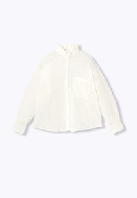 Chemise blanche brodée avec un col mao, une fermeture à boutons sur le devant, des manches longues et une poche poitrine. Présente des motifs ajourés sur toute la surface.