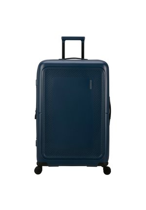 Hard-shell suitcase in dark blue, featuring diagonal textured patterns, a retractable handle, and four spinning wheels for mobility.