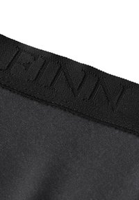 Black fabric waistband with embossed "FINN" logo, smooth texture, and a minimalist design. The band is stitched and securely attached.