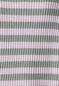 Knit textile featuring horizontal stripes in soft green and light pink. Ribbed texture, with alternating wide and narrow bands.