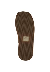 Brown rubber shoe sole with herringbone texture, featuring a rectangular label with "GANT" and "EST. 1949 NEW HAVEN. CT." embossed.