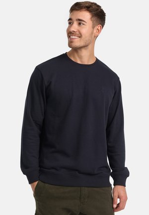 Navy crewneck sweatshirt made of soft material, featuring ribbed cuffs and hem, with a subtle logo detail on the chest.