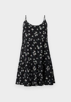 Juoda suknelė be rankovių, su plonomis petnešėlėmis, sluoksniuota suknele ir baltojį ramunėlių gėlių raštu su žaliais lapais.