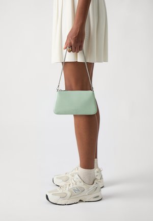 Mint green leather clutch bag with a silver chain strap, rectangular shape, and a minimalistic design. Features a zip closure and logo detail.