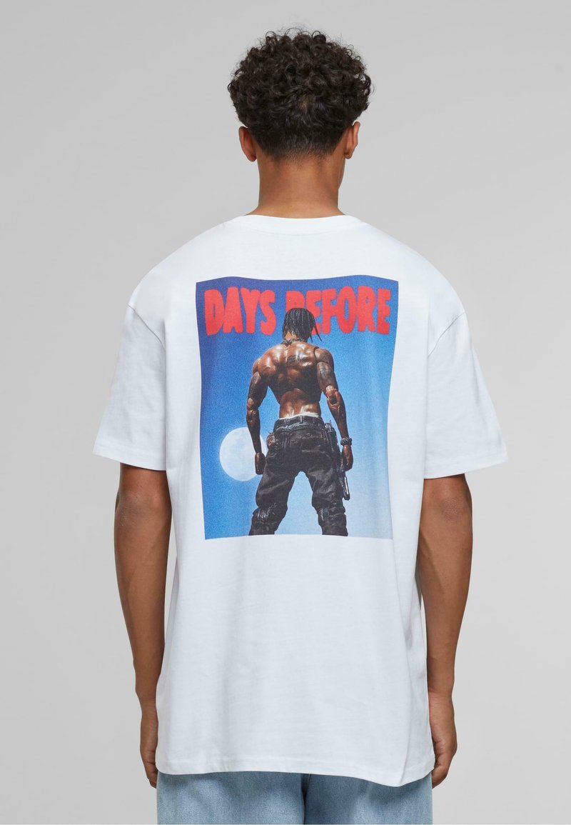 White short-sleeve t-shirt featuring a large graphic on the back, displaying a figure against a blue background with the text "DAYS BEFORE."